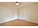 Neutral bedroom featuring parquet flooring, ceiling fan, and white double door closet providing ample storage at 435 Crabapple Rd, Fayetteville, GA 30215