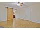 Light filled bedroom with ceiling fan and sliding barn door that has a view to bathroom at 435 Crabapple Rd, Fayetteville, GA 30215