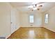 Neutral bedroom with parquet floors, ceiling fan, and view to bathroom with wood vanity at 435 Crabapple Rd, Fayetteville, GA 30215