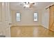 Spacious bedroom featuring parquet floors, a ceiling fan, and a wood-look sliding barn door at 435 Crabapple Rd, Fayetteville, GA 30215