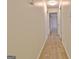 Long hallway with neutral walls and a light-colored hardwood floor at 435 Crabapple Rd, Fayetteville, GA 30215