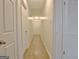 Bright hallway featuring wood-look floors and white doors to bedrooms and other rooms at 435 Crabapple Rd, Fayetteville, GA 30215