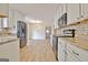 Open-concept kitchen with stainless steel appliances, and seamless flow to the dining area at 435 Crabapple Rd, Fayetteville, GA 30215