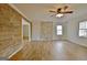 Spacious living room with hardwood floors and a stone accent wall at 435 Crabapple Rd, Fayetteville, GA 30215