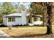 Newly renovated ranch home with white brick exterior and landscaped yard at 32 Collins Rd, Locust Grove, GA 30248