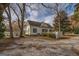 Classic two-story home featuring a spacious parking area and mature trees in a quiet neighborhood at 3810 2Nd Ave, Mansfield, GA 30055