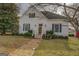 Quaint home showcasing its well-manicured lawn and inviting entrance with stairs leading to the front door and mature trees at 3810 2Nd Ave, Mansfield, GA 30055