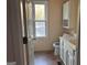 Cozy bathroom with a single vanity, toilet, and bright window at 7472 Woods Ct, Lithonia, GA 30058