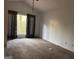 Bedroom with a window and patterned curtains, providing natural light at 7472 Woods Ct, Lithonia, GA 30058