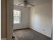 Bedroom with ceiling fan and natural light streaming through a window at 7472 Woods Ct, Lithonia, GA 30058