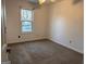 Neutral bedroom featuring natural light from the window and a ceiling fan fixture at 7472 Woods Ct, Lithonia, GA 30058