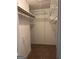 Walk-in closet offering ample storage with multiple shelves and hanging rods at 7472 Woods Ct, Lithonia, GA 30058