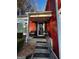 Covered front porch with outdoor seating welcomes you to this charming home with black railing at 7472 Woods Ct, Lithonia, GA 30058