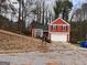 Charming two-story home with attached garage and well-maintained lawn at 7472 Woods Ct, Lithonia, GA 30058