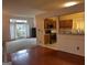 Open-concept kitchen with stainless steel appliances, wood cabinets, granite countertops and adjacent living room at 7472 Woods Ct, Lithonia, GA 30058