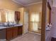 Well-lit kitchen with wood cabinets, stainless steel appliances, granite countertops, and tile flooring at 7472 Woods Ct, Lithonia, GA 30058