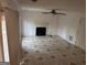 Bright living room with fireplace and tile flooring, ready for updates at 7472 Woods Ct, Lithonia, GA 30058