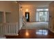 Bright living room featuring an elegant chandelier, staircase, and large window with natural light at 7472 Woods Ct, Lithonia, GA 30058