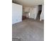 Expansive living room with staircase, neutral carpet flooring, and entry to the living area at 7472 Woods Ct, Lithonia, GA 30058