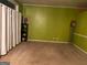 Spacious living room with neutral carpet, bright green walls, white curtains, and ample space for furniture at 7472 Woods Ct, Lithonia, GA 30058