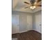 Bedroom featuring neutral walls, fan/light fixture, laminate flooring, and multiple closets at 251 Ralph David Abernathy Sw Blvd, Atlanta, GA 30312