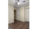 A bedroom with wood floor, ceiling fan, closet with white doors and white trim at 251 Ralph David Abernathy Sw Blvd, Atlanta, GA 30312