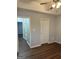 A cozy bedroom featuring hardwood floors, neutral walls, ceiling fan and a doorway leading to another room at 251 Ralph David Abernathy Sw Blvd, Atlanta, GA 30312