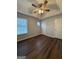 Bedroom has laminate floors, a ceiling fan, and natural light from the window at 251 Ralph David Abernathy Sw Blvd, Atlanta, GA 30312