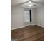 Bedroom with laminate floors, fan, and a large window with privacy blinds at 251 Ralph David Abernathy Sw Blvd, Atlanta, GA 30312