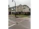 A low-angle side exterior view of a multi-Gathering townhouse with brick and siding details at 251 Ralph David Abernathy Sw Blvd, Atlanta, GA 30312