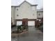 Rear exterior view of townhome garages with driveways and garden beds at 251 Ralph David Abernathy Sw Blvd, Atlanta, GA 30312