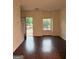 Sunlit living room with wood floors and an open door to a porch at 251 Ralph David Abernathy Sw Blvd, Atlanta, GA 30312