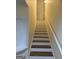 Staircase featuring white risers, wood treads, white walls and a pendant light at 251 Ralph David Abernathy Sw Blvd, Atlanta, GA 30312