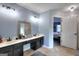 Double vanity bathroom with dark cabinets and access to bedroom at 2744 Amber Springs Way, Buford, GA 30519