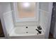 Bathroom featuring a bathtub with updated fixtures and tile at 2744 Amber Springs Way, Buford, GA 30519