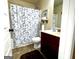 Cozy bathroom with patterned shower curtain, dark cabinets, and clean fixtures, providing a functional space at 80 Tanners Ct, Covington, GA 30016