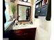 Well-lit bathroom with a dark vanity, a framed mirror and modern fixtures at 80 Tanners Ct, Covington, GA 30016