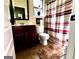 Cozy bathroom featuring a vanity with a mirror, toilet, and a shower with a striped curtain at 80 Tanners Ct, Covington, GA 30016