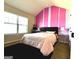 Bright bedroom with large window, pink and white striped accent wall, and plush carpet, perfect for relaxation at 80 Tanners Ct, Covington, GA 30016