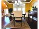 Dining room with a bay window, hardwood floors, a chandelier, and traditional furniture at 80 Tanners Ct, Covington, GA 30016
