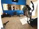Spacious home exercise room featuring an elliptical machine, weight bench, and large mirror at 80 Tanners Ct, Covington, GA 30016