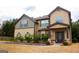 Charming home exterior with unique architectural details, a covered porch, and professionally landscaped front yard at 80 Tanners Ct, Covington, GA 30016
