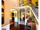 View of entryway from staircase showcasing arched entrances and gleaming hardwood floors at 80 Tanners Ct, Covington, GA 30016