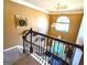 View of foyer from top of staircase with dark wooden railing at 80 Tanners Ct, Covington, GA 30016