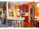 Bright kitchen featuring granite countertops, wooden cabinets, and hardwood floors at 80 Tanners Ct, Covington, GA 30016