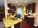 Well-lit kitchen featuring stainless steel appliances, wooden cabinets, a granite countertop and a modern sink at 80 Tanners Ct, Covington, GA 30016