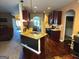 Open kitchen with wooden floors, granite counters, island and modern appliances at 80 Tanners Ct, Covington, GA 30016
