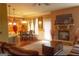 Cozy living room with a fireplace, ceiling fan, and hardwood floors near dining at 80 Tanners Ct, Covington, GA 30016