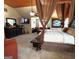 Carpeted main bedroom with canopy bed and a wall mounted television above the dresser at 80 Tanners Ct, Covington, GA 30016