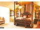 A luxurious bedroom featuring a regal canopy bed, sitting area, and elegant decor at 80 Tanners Ct, Covington, GA 30016